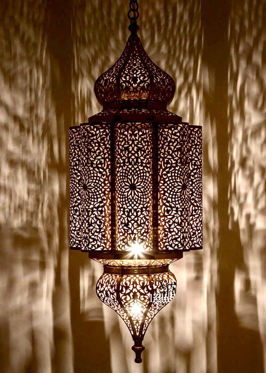 Close-up of a handmade Moroccan ceiling lantern showcasing detailed hand-drilled patterns and authentic brass finish.