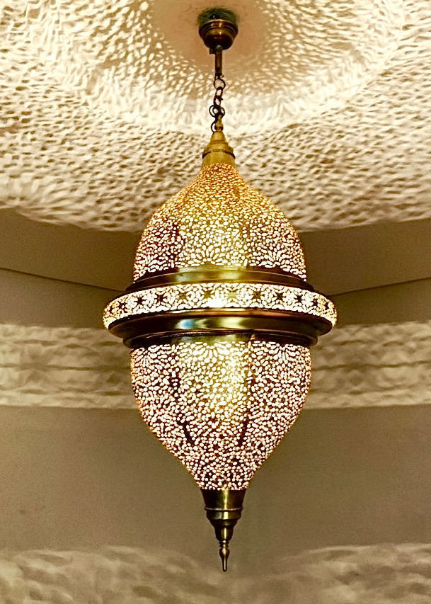 Grand Moroccan brass chandelier featuring traditional hand-perforated floral designs.
