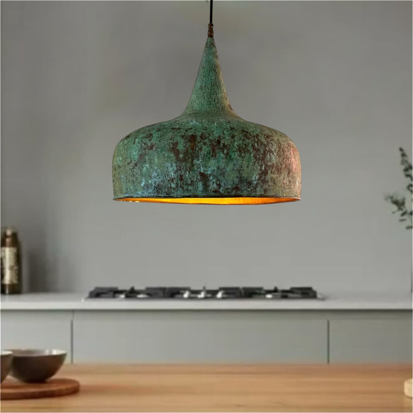 Close-up of the handcrafted hammered texture and authentic green verdigris patina on a Moroccan brass lamp shade.