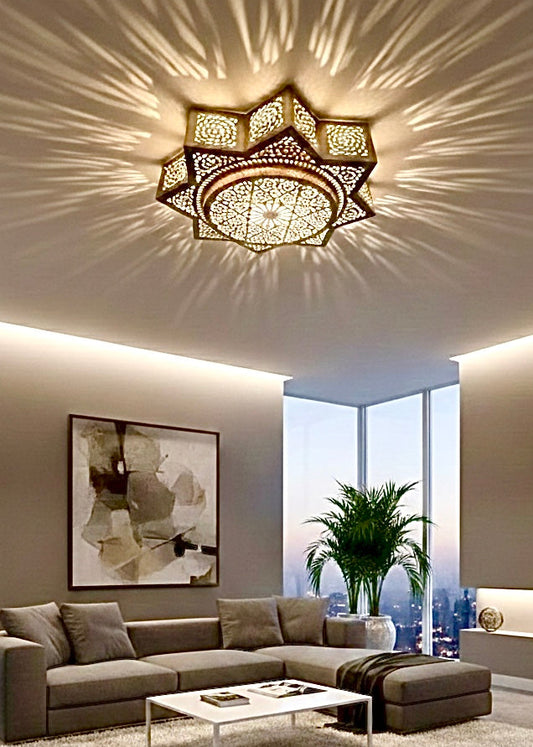 Large handmade Moroccan brass flush mount ceiling light casting geometric shadow patterns in a modern neutral living room.