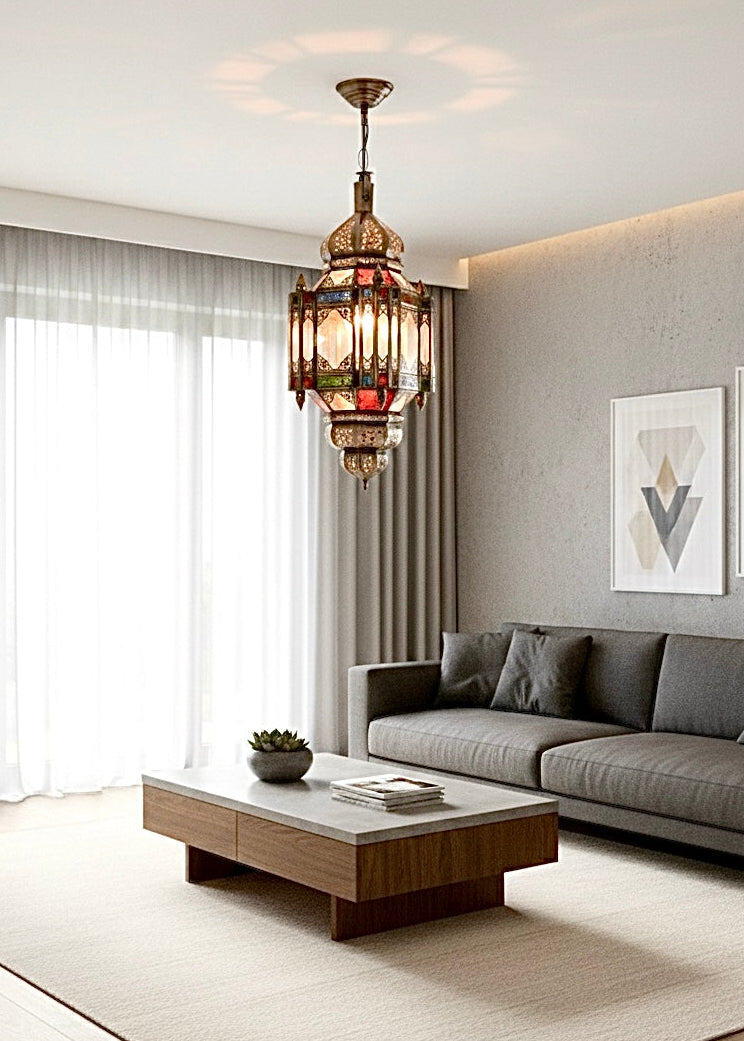A handcrafted Moroccan brass lantern with stained glass panels hanging in a modern living room.