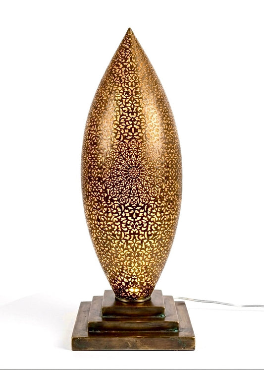 intricate geometric perforations casting a warm glow, antique brass finish on a tiered square base.⁠