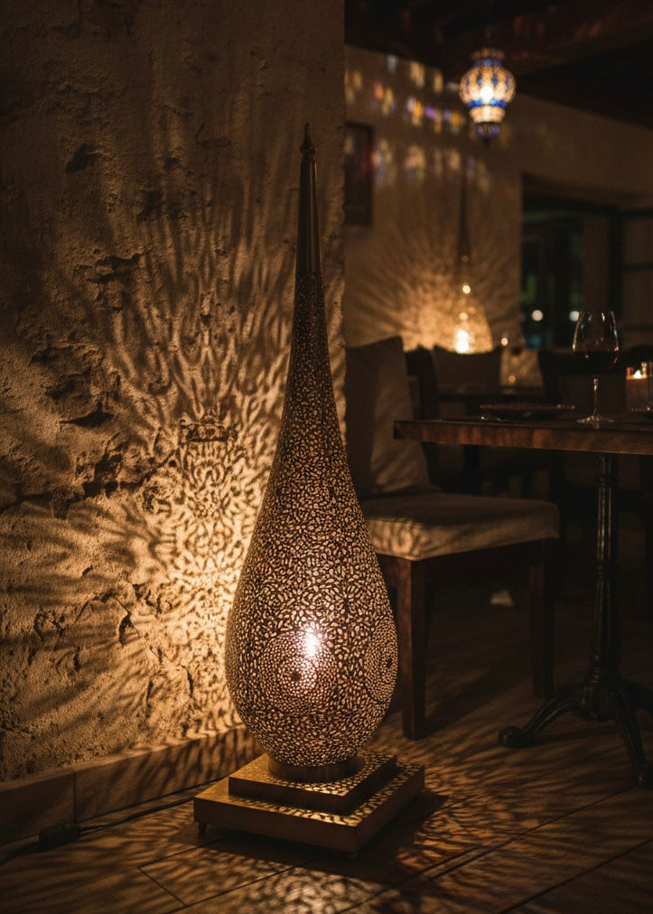 Detailed artisan craftsmanship on a traditional Moroccan brass standing lamp.