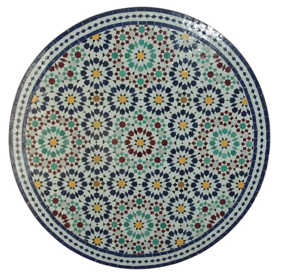 Round Moroccan Zellige mosaic table with blue and white geometric star patterns.