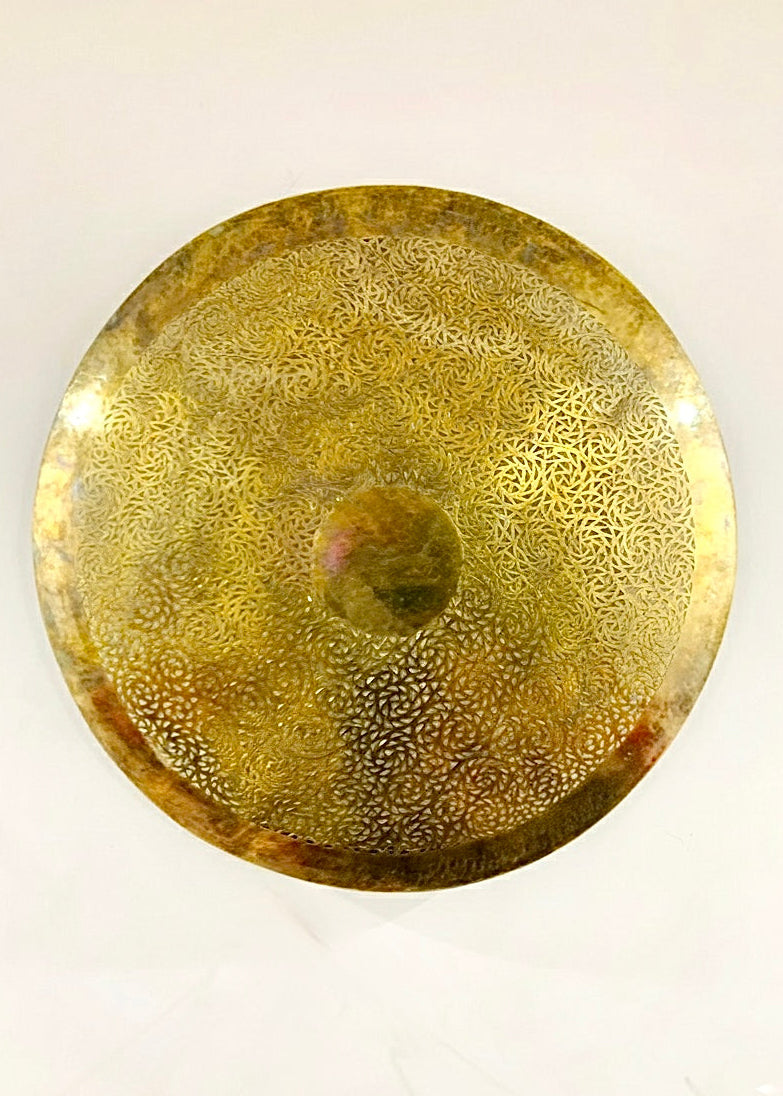 Handmade Moroccan brass wall light or sconce, creating a warm golden glow and beautiful shadows for bedroom or living room walls.
