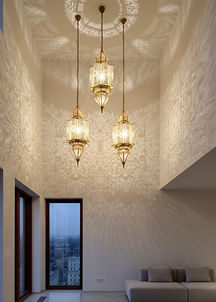 Sleek cylindrical brass pendant light with traditional Moroccan etchings for a contemporary look.