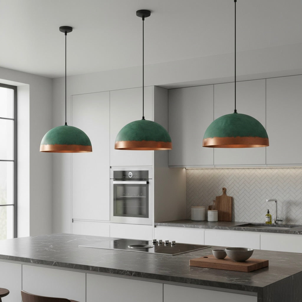 Modern patina copper dome light hanging over a kitchen counter in a minimalist home.