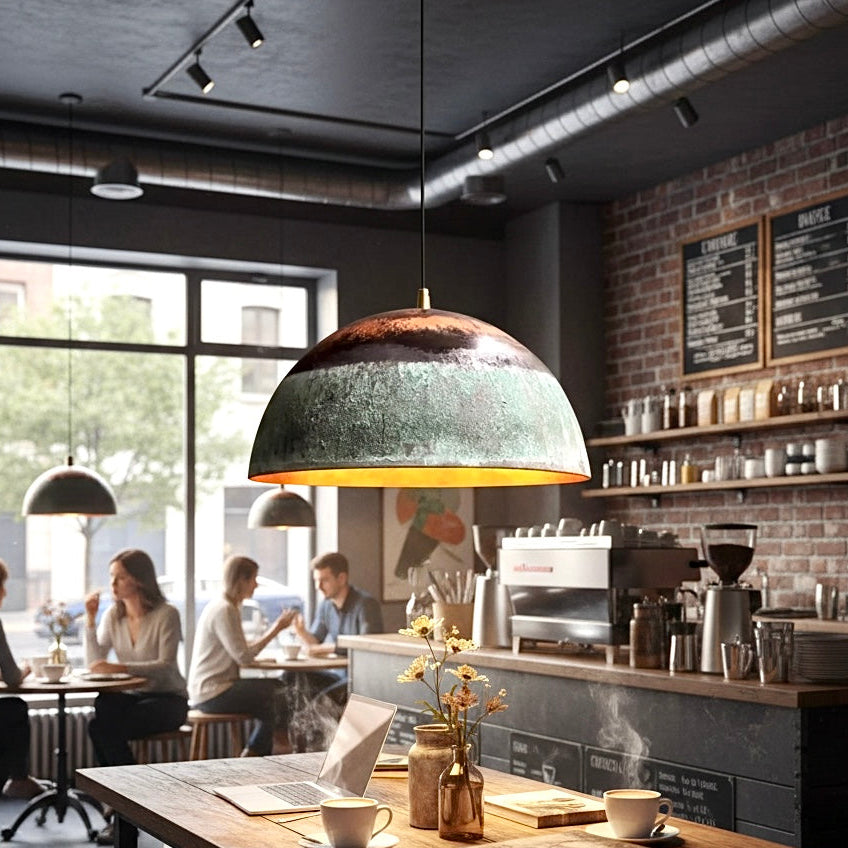 Industrial patina green and copper red dome lamp for a modern coffee shop interior.