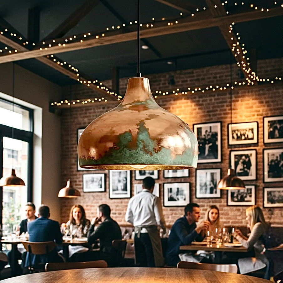 Industrial verdigris copper dome lamp with polished interior for a stylish bar lighting.