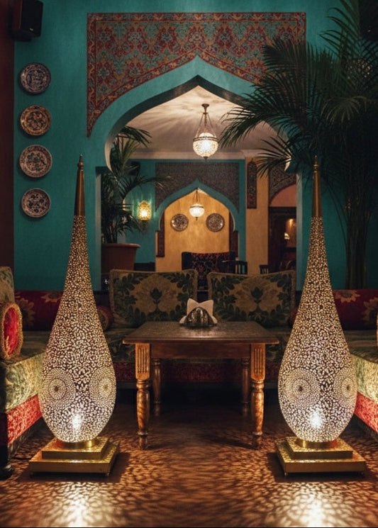 Close-up of handmade geometric engravings on a gold Moroccan brass lamp.