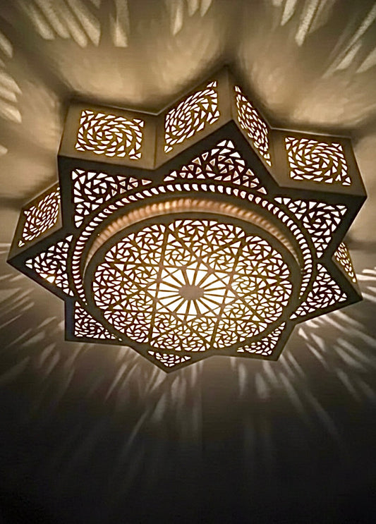 Close-up of 100% handmade Moroccan brass lamp showing detailed star geometric patterns and traditional craftsmanship.