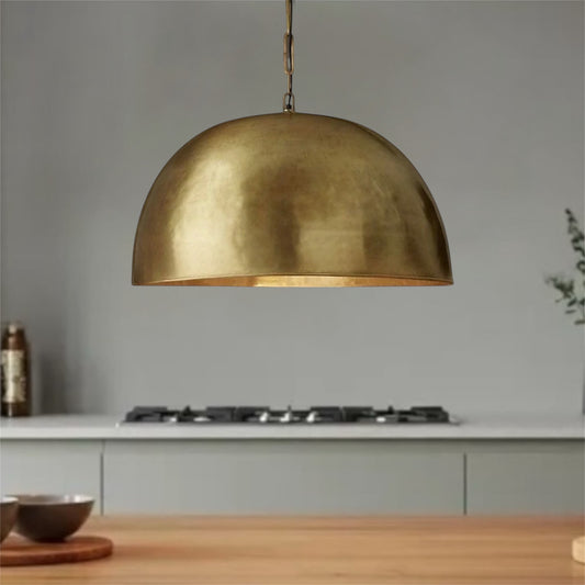Large brass dome pendant light with an antique finish.