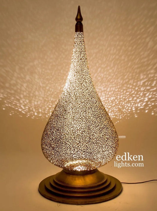 Large handmade Moroccan brass table lamp with teardrop design and intricate shadow patterns.
