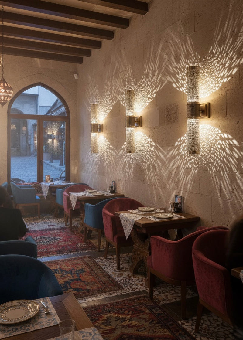 Decorative brass wall sconce installed in a bedroom creating a warm and relaxing atmosphere.