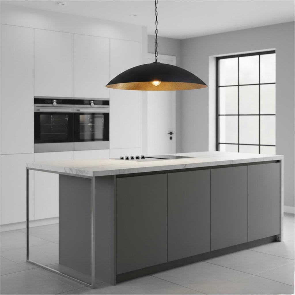 Sleek black pendant light hanging above a grey marble kitchen island in a bright white kitchen.