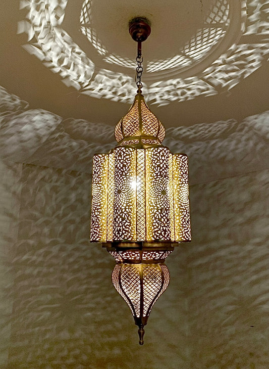 Close-up of a hand-etched brass hanging fixture showing high-quality artisan craftsmanship.