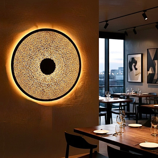 Large round Moroccan brass flush mount lamp installed in a modern restaurant setting for a warm ambient glow.