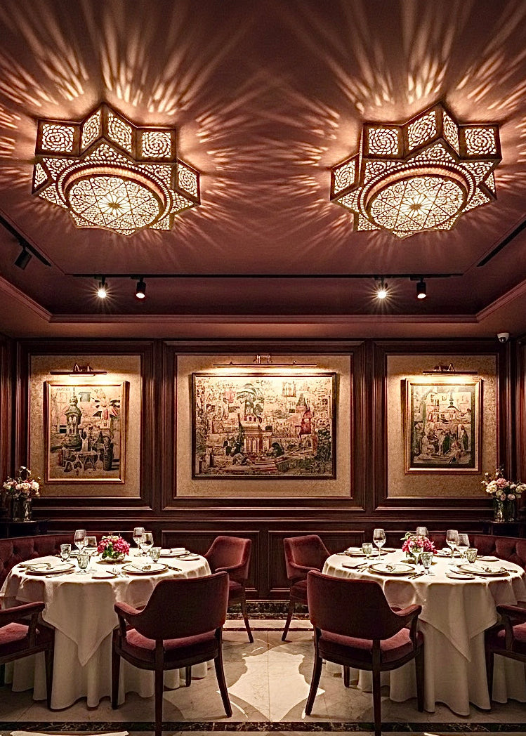 Two Moroccan brass flush mount lights installed in a luxury dining room, highlighting the elegant gold finish and ceiling light art.