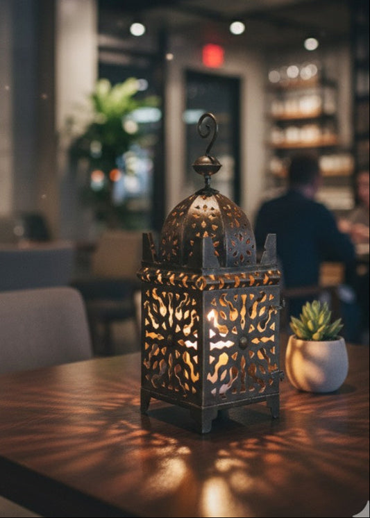 Modern outdoor swimming pool area decorated with multiple Moroccan metal lanterns at sunset.