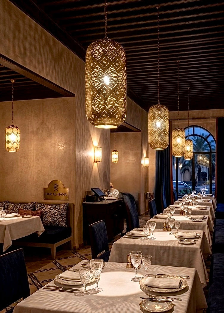 High-end restaurant dining area decorated with multiple authentic Moroccan brass pendant lights hanging from a dark wood ceiling.