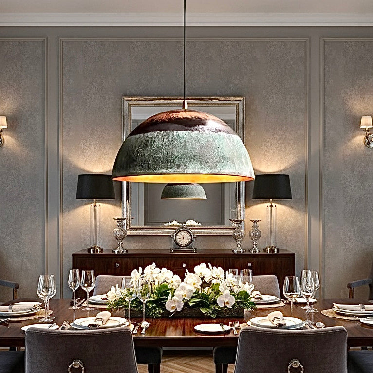 Large luxury verdigris copper dome lamp over a formal dining table with gray decor.