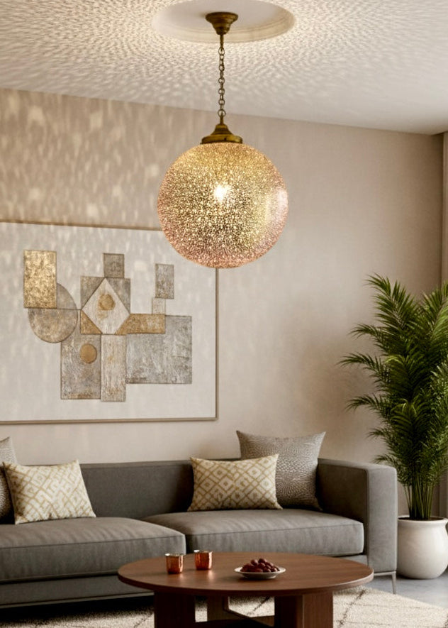 A modern minimalist living room featuring a large gold Moroccan globe pendant light as a statement centerpiece Black Brass