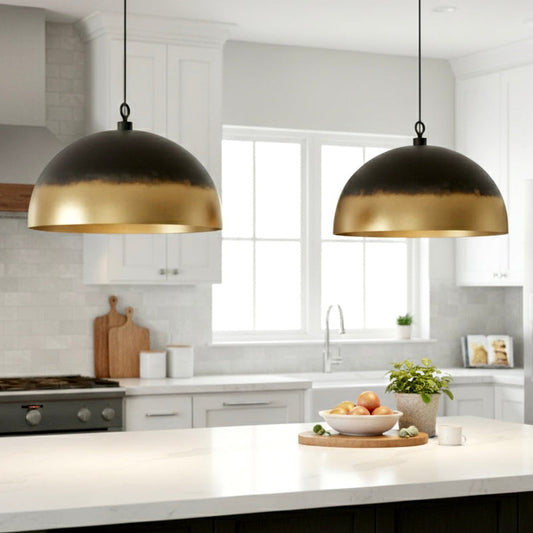 Modern matte black dome pendant light with a polished gold brass interior.