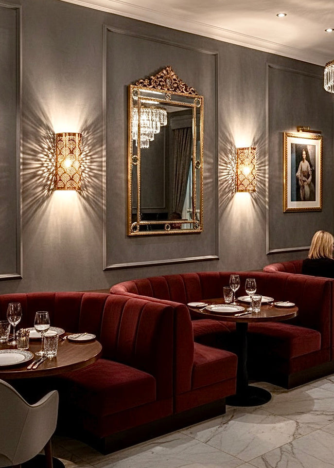 Modern black brass wall sconce, artisan-crafted with unique light-filtering perforations.