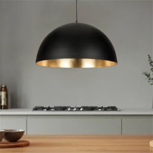 Modern brushed brass dome pendant light hanging from ceiling