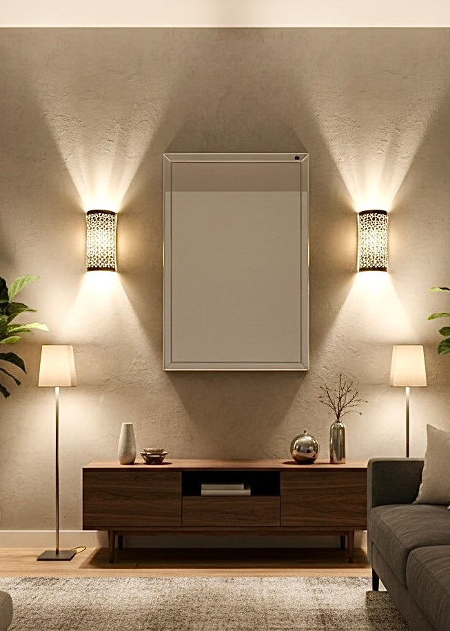 Two modern brass wall sconces installed in a living room, adding a luxury artisanal touch to the interior design.