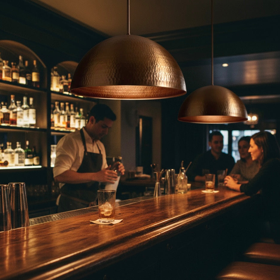 Modern copper dome hanging lamp styled over a kitchen island for contemporary decor.