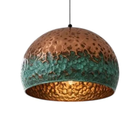 Handmade modern copper dome light with hammered texture and green patina finish, isolated on white