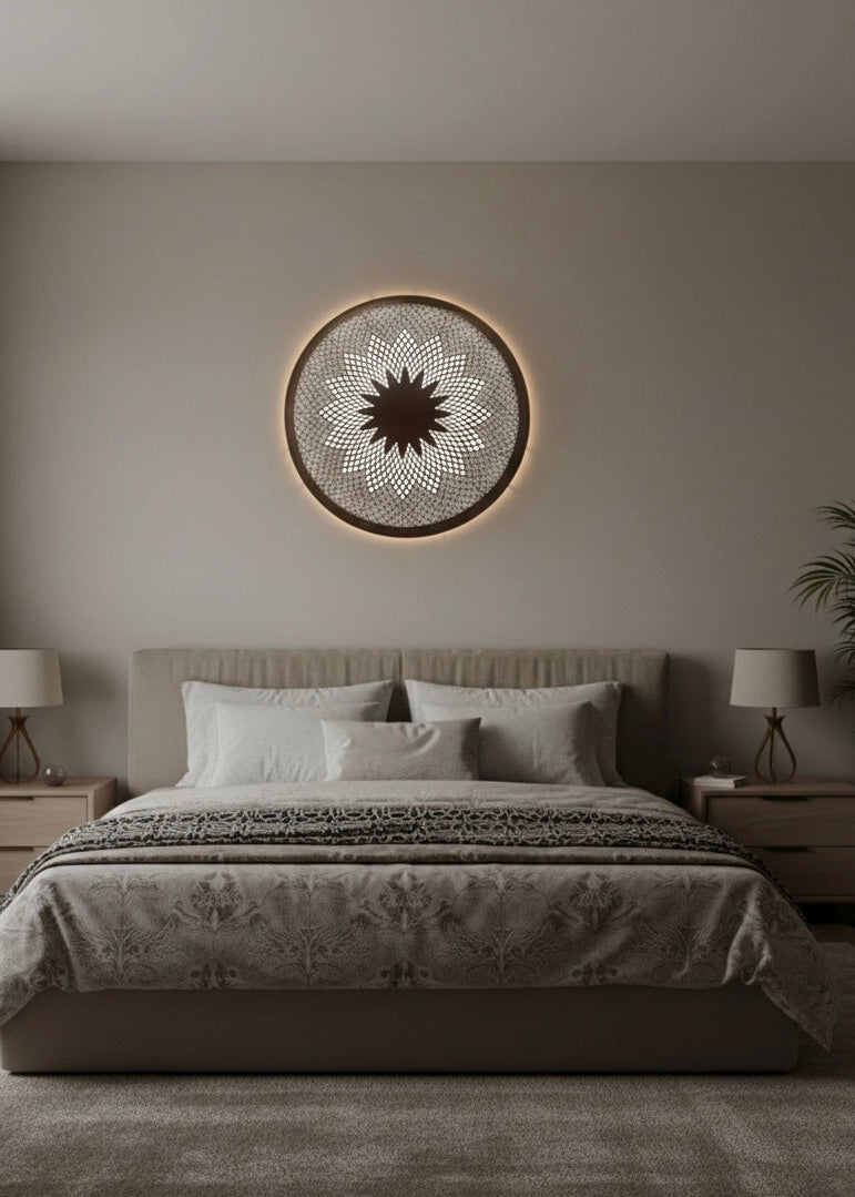 A round Moroccan brass flush mount lamp providing soft ambient light above a bed in a minimalist bedroom.