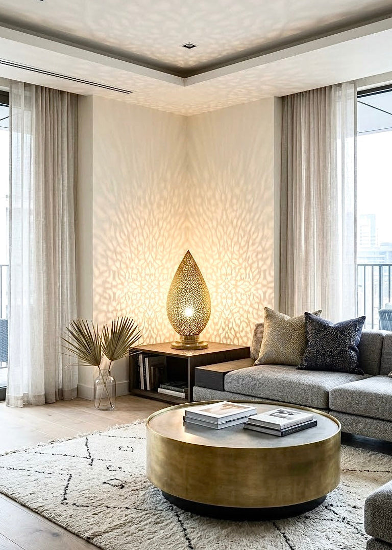 Moroccan brass accent table lamp placed on a side table in a contemporary living room with a round brass coffee table