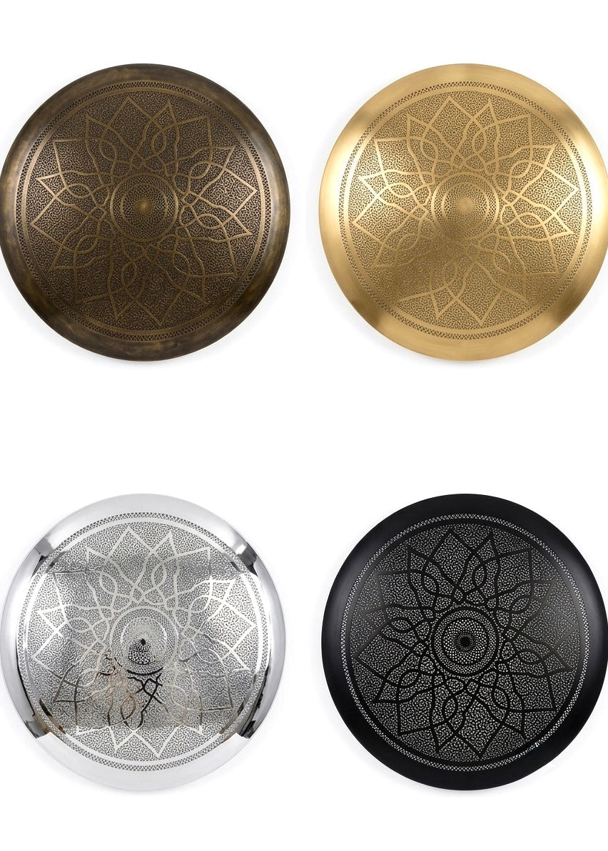 Four finishes of handmade Moroccan brass pendant lights and wall sconces including smooth brushed brass, oxidized patina, silver, and matte black.⁠