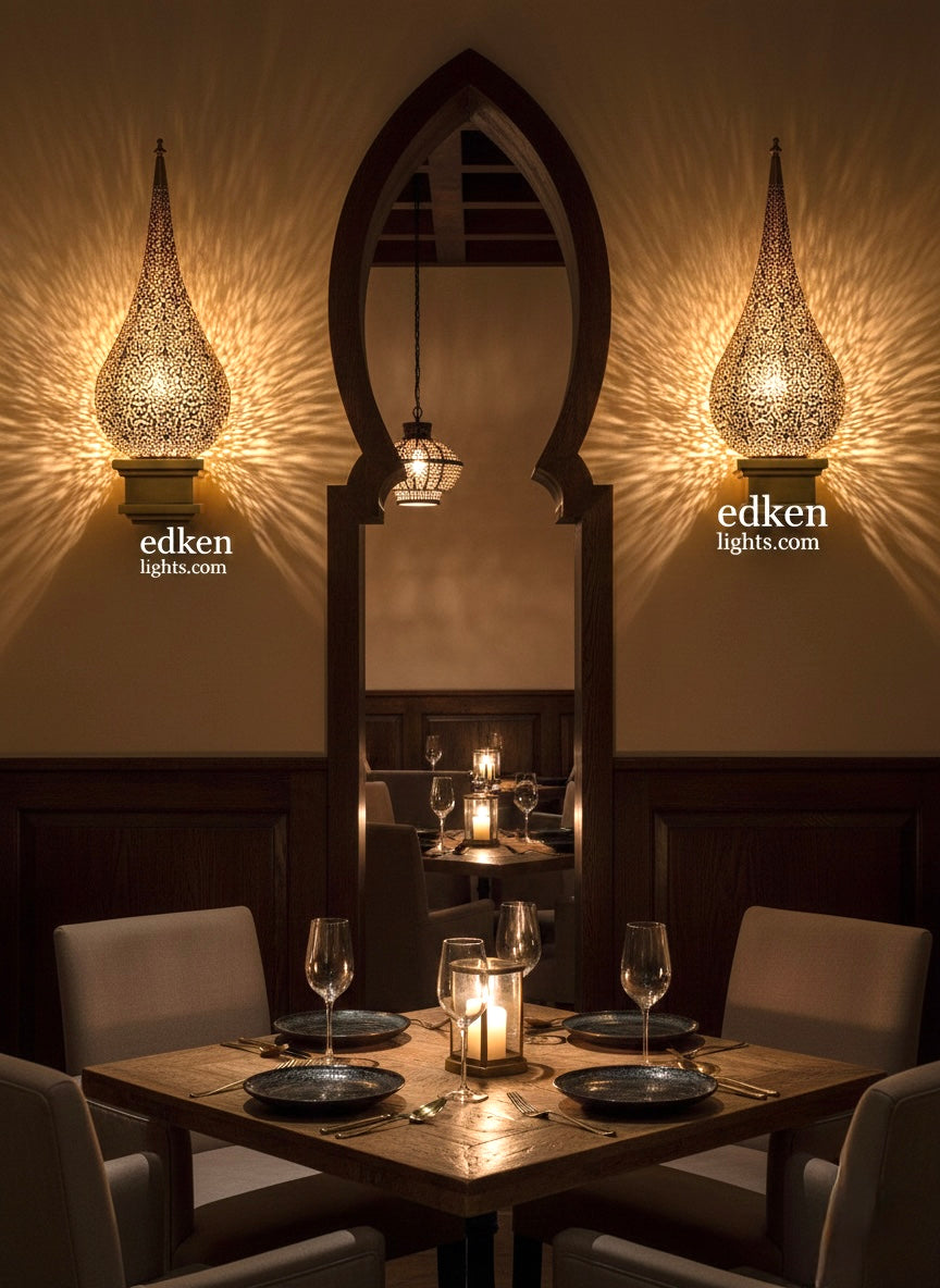 Warm ambient light glowing through a Moroccan brass wall sconce, casting geometric shadow patterns on the wall.