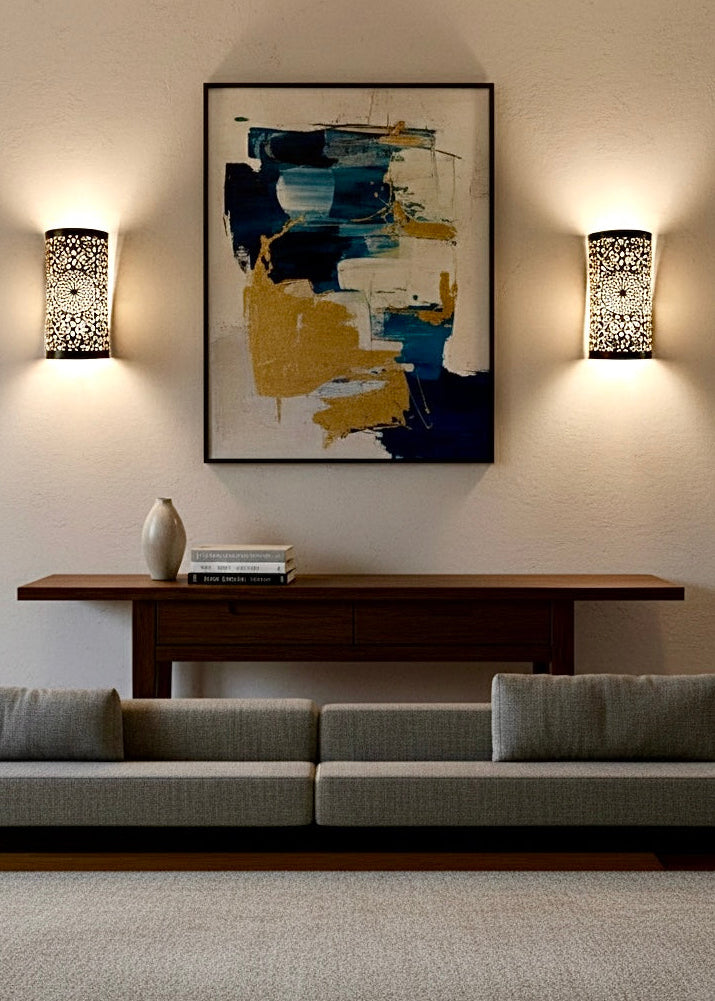 Moroccan handmade brass wall sconce flanking modern art in a bohemian living room.