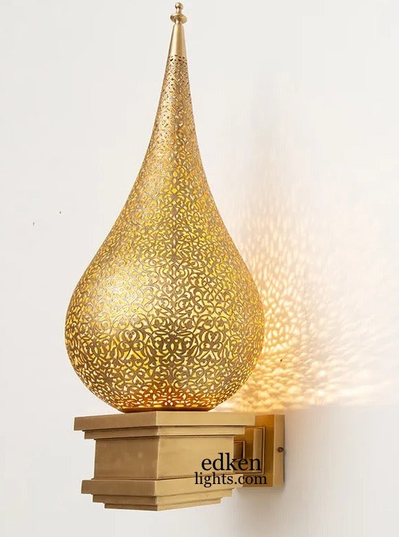 Side view of a Moroccan brass wall light mounted on a decorative base, showing the elegant spire design.