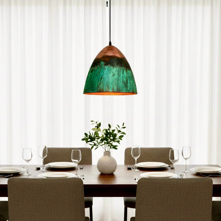 Moroccan handmade dome pendant light in green patina and copper red finish hanging above dining table, modern ceiling lighting for dining room decor.