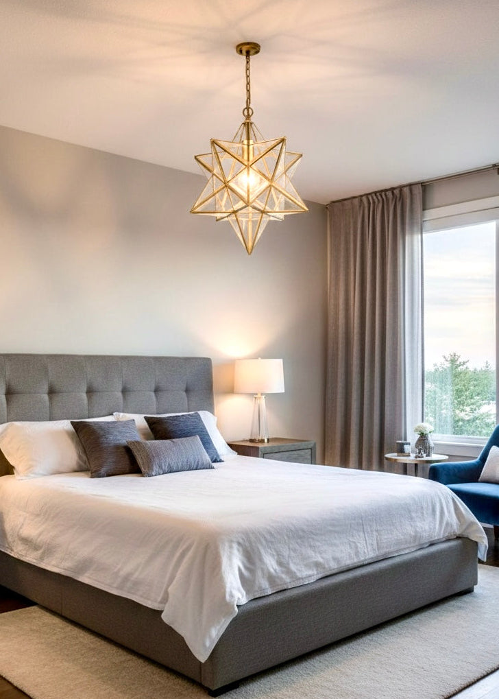 A large brass Moroccan star light fixture hanging over a modern bed in a neutral-toned bedroom.
