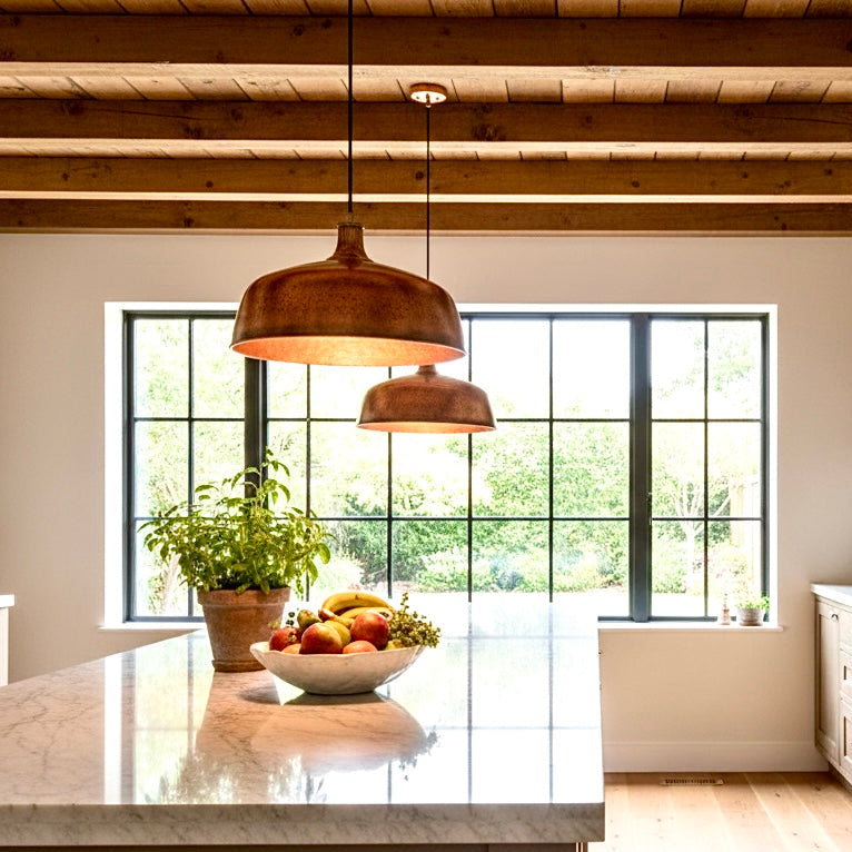 Moroccan handmade copper dome lamp hanging in a modern white kitchen with navy cabinets
