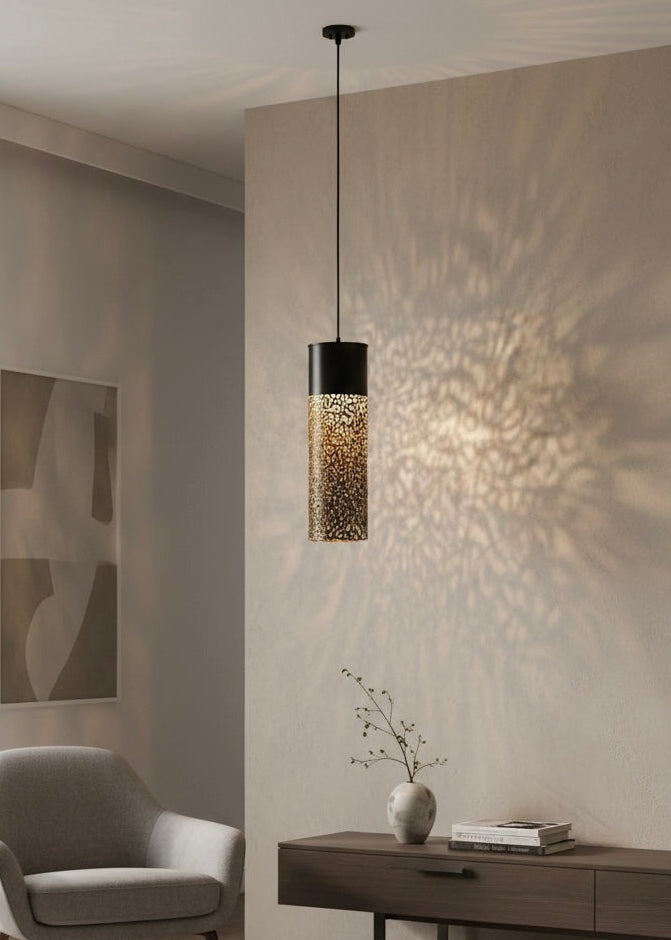 Decorative Moroccan brass lamp casting warm oriental shadow patterns on a wall, perfect for boho chic interiors.