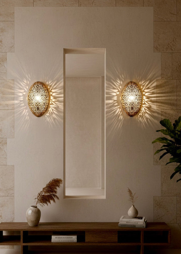 A Moroccan brass sconce illuminating a hallway with beautiful exotic geometric shadow art patterns.