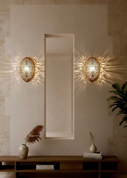 A Moroccan brass sconce illuminating a hallway with beautiful exotic geometric shadow art patterns.