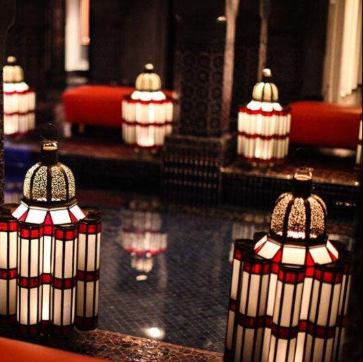 Moroccan brass and glass table lamp featuring traditional geometric metalwork