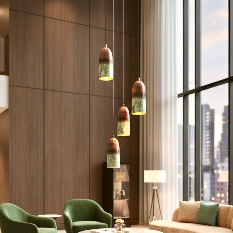 Creative cluster of four patina copper pendant lights in a high-ceiling modern living room