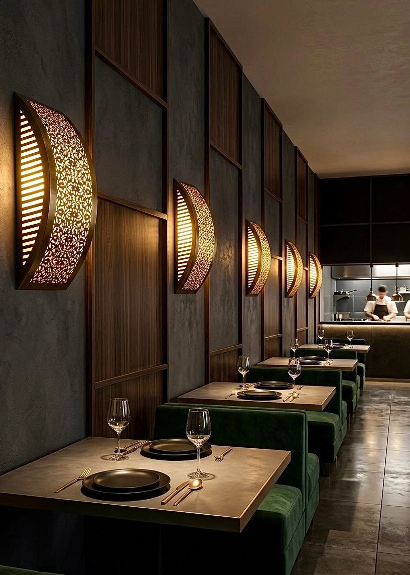 Elegant restaurant seating area illuminated by several Moroccan brass wall sconces, creating a cozy and high-end dining vibe.