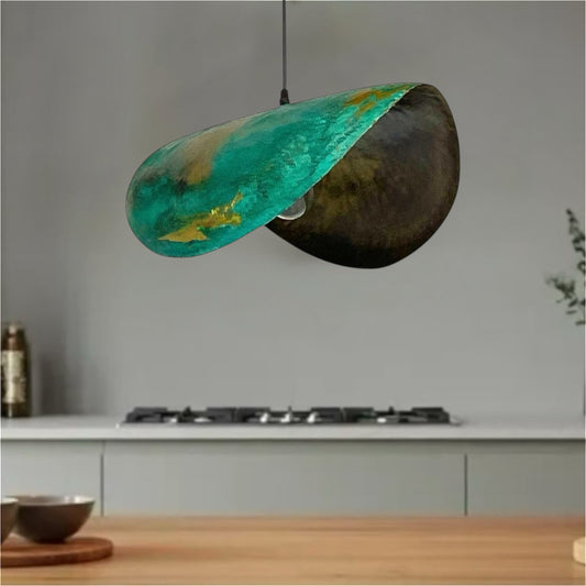 Oxidized bronze brass dome pendant light with natural green patina finish and exposed bulb.