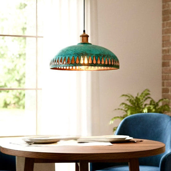 Rustic yet modern patina green copper dome light illuminating a dining room table.