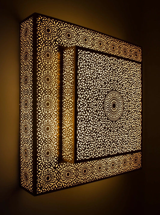 Moroccan ceiling light casting decorative shadow patterns on walls.